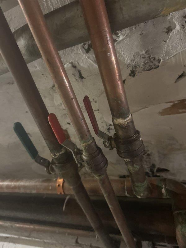 Coordinated scheduled water shut down with building management to facilitate plumbing repairs on aging copper supply lines and ball valve assembly. Replaced deteriorated brass valves showing corrosion and oxidation, addressing potential leak points in the horizontal piping system located in the utility area. Work was completed during mid-morning hours to minimize disruption to building residents.