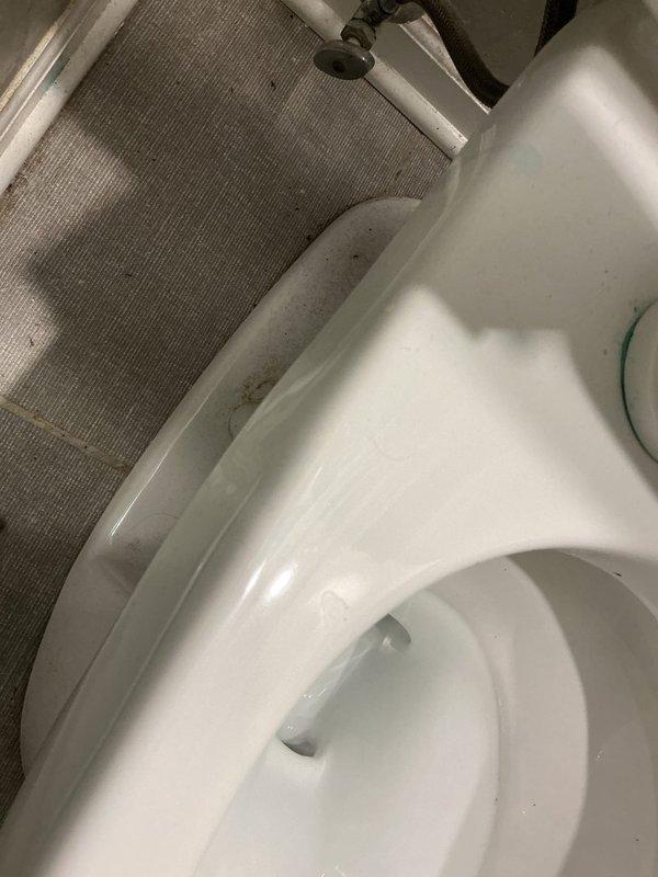 Responded to concerns about ongoing floor buckling near refrigerator following previous ice maker supply line repairs. Conducted thorough inspection of bathroom plumbing fixtures, including toilet and associated supply lines, to identify potential secondary water sources affecting adjacent living areas in garden-level apartment. Documented current condition of fixtures and surrounding areas with photographic evidence for assessment and estimate preparation.