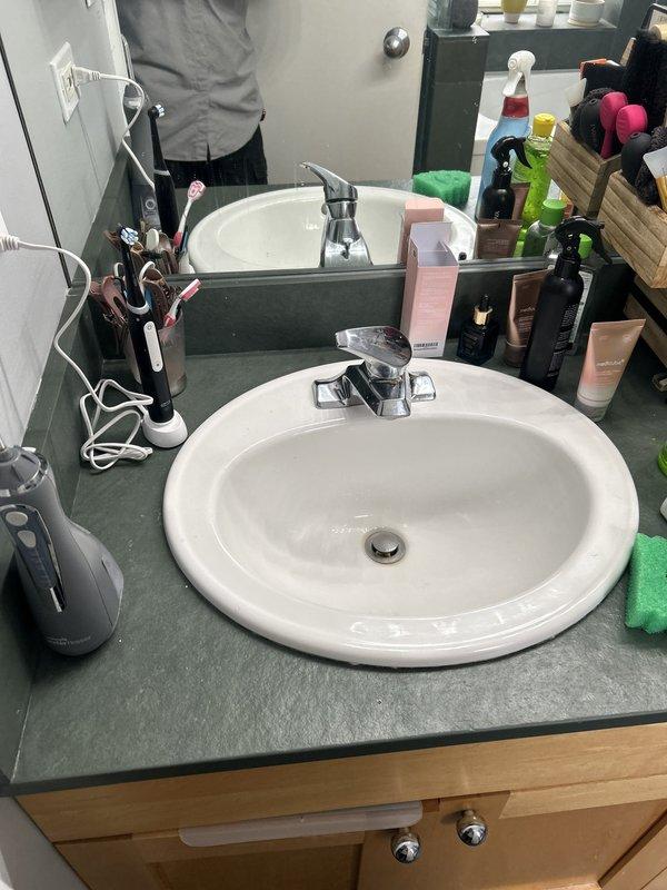 Assessed low water pressure issue in residential bathroom affecting dual-head shower system and vanity faucet. Determined that building-wide plumbing work is required to resolve pressure concerns. Coordinated with property owner to schedule building shut down for comprehensive system repairs, collected down payment, and arranged follow-up service appointment to complete necessary corrective work.