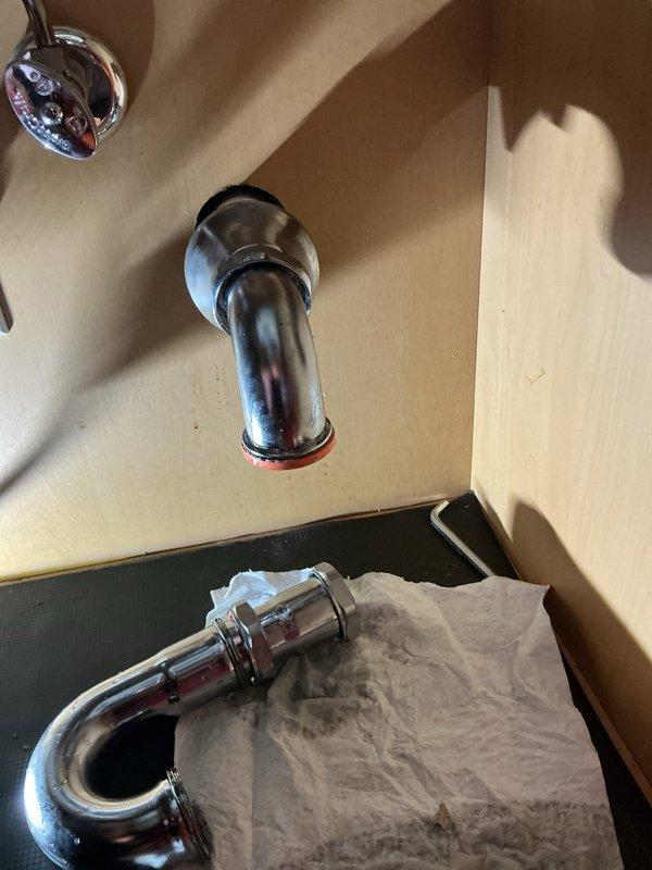 Completed garbage disposal installation in kitchen. Upon initial setup, identified leak in drain pipe connection. Replaced chrome-plated P-trap assembly and drain fittings to ensure proper seal. Tested system for leaks and verified proper drainage operation before completion.