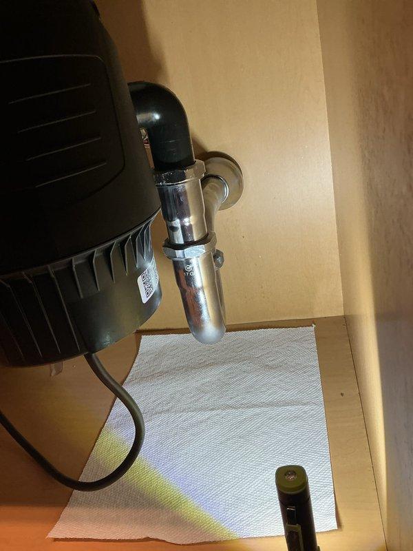 Completed garbage disposal installation in kitchen. Upon initial setup, identified leak in drain pipe connection. Replaced chrome-plated P-trap assembly and drain fittings to ensure proper seal. Tested system for leaks and verified proper drainage operation before completion.