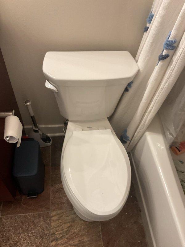 Responded to service call for water backing up through floor drain in residential bathroom. Upon arrival, inspected bathroom fixtures and floor drain to assess drainage issue. Documented existing conditions of bathroom plumbing system including toilet, bathtub, and floor drain location. Investigation revealed symptoms consistent with main line blockage causing wastewater to seek alternative exit points through lowest available drain opening.