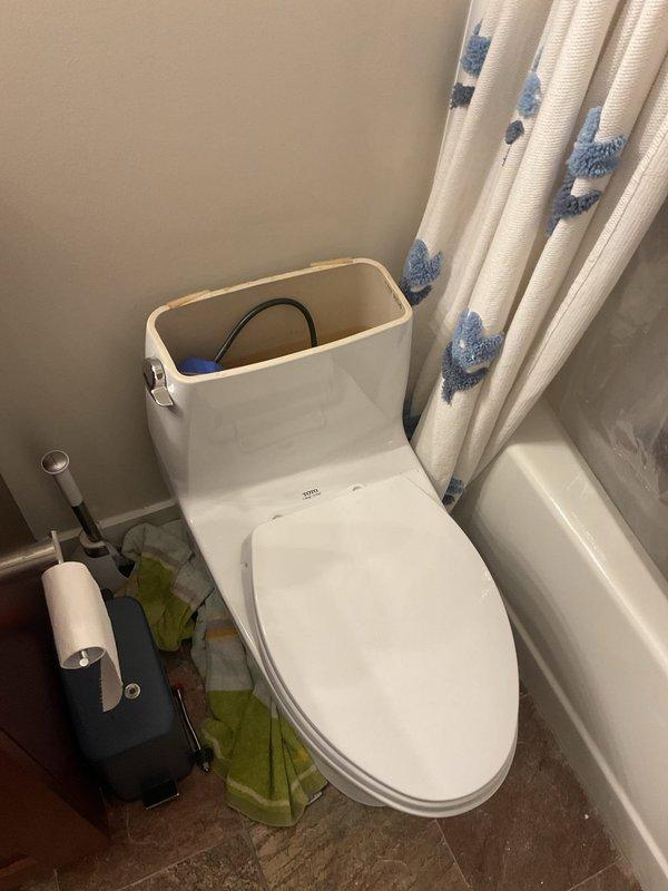 Responded to service call for water backing up through floor drain in residential bathroom. Upon arrival, inspected bathroom fixtures and floor drain to assess drainage issue. Documented existing conditions of bathroom plumbing system including toilet, bathtub, and floor drain location. Investigation revealed symptoms consistent with main line blockage causing wastewater to seek alternative exit points through lowest available drain opening.
