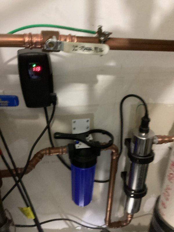 Performed routine maintenance on whole-home water filtration system originally installed by our company. Replaced filter cartridge in blue housing unit using customer-supplied replacement filter. Verified proper operation of system including electronic control unit, copper piping connections, and inline filtration components, ensuring no leaks and confirming adequate water pressure and flow throughout the system.