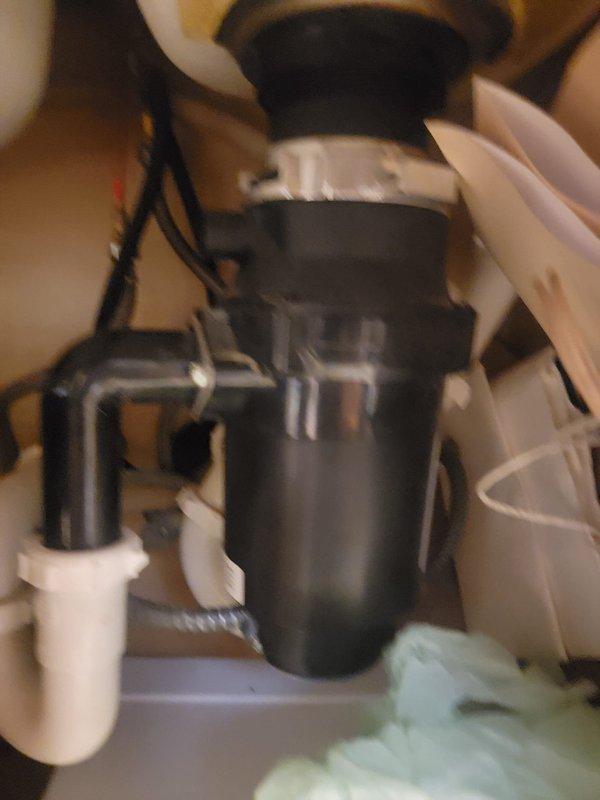 Responded to a fully clogged toilet that remained blocked despite multiple clearing attempts. Upon inspection, discovered the issue was related to the kitchen drain system connected to the garbage disposal unit. Cleared the obstruction in the disposal discharge line and verified proper drainage flow through the P-trap and connecting PVC pipes. Tested all fixtures to ensure complete restoration of drainage function.
