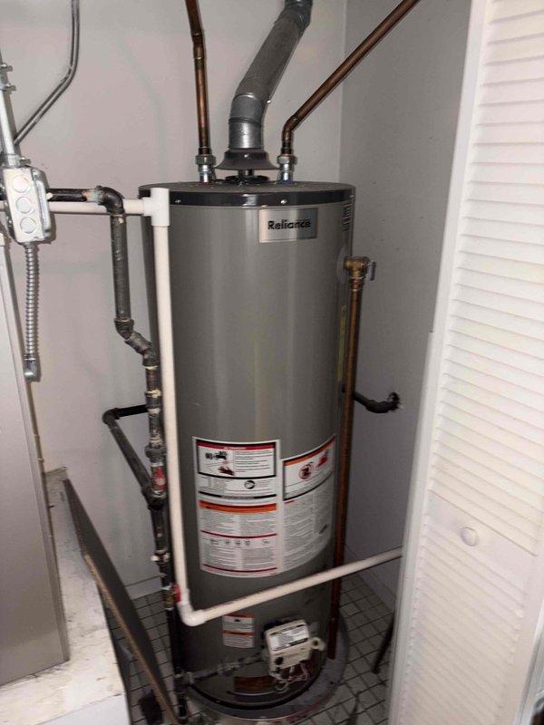 Responded to service call for non-operational Honeywell tanked water heater that failed to reignite. Upon inspection, assessed the existing Reliance brand water heater unit and associated plumbing connections, including copper supply lines, pressure relief valve piping, and exhaust venting system. Documented current installation configuration with copper hot and cold water lines, gas supply connections, and proper venting through metal ductwork. Evaluated unit's operational status and presented repair versus replacement options to proceed with appropriate solution.