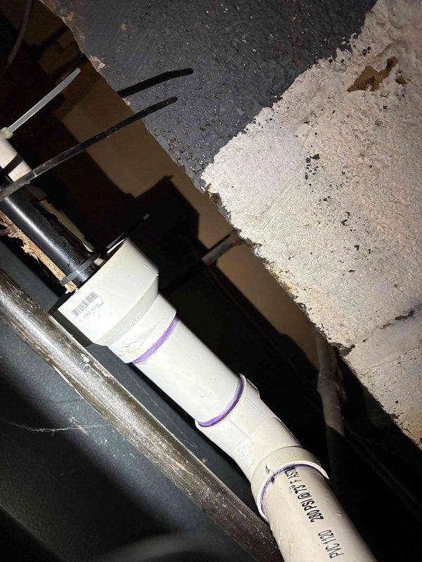 Responded to basement water leak complaint and conducted thorough inspection of plumbing infrastructure. Upon examination, identified corroded copper piping showing significant rust and oxidation, indicating prolonged moisture exposure and potential leak source. Assessed PVC drainage system and HVAC components in utility area, documenting existing conditions including weathered ductwork with water staining. Photographed affected plumbing assembly for record-keeping purposes, capturing deteriorated pipe conditions and surrounding mechanical systems requiring monitoring for future maintenance needs.