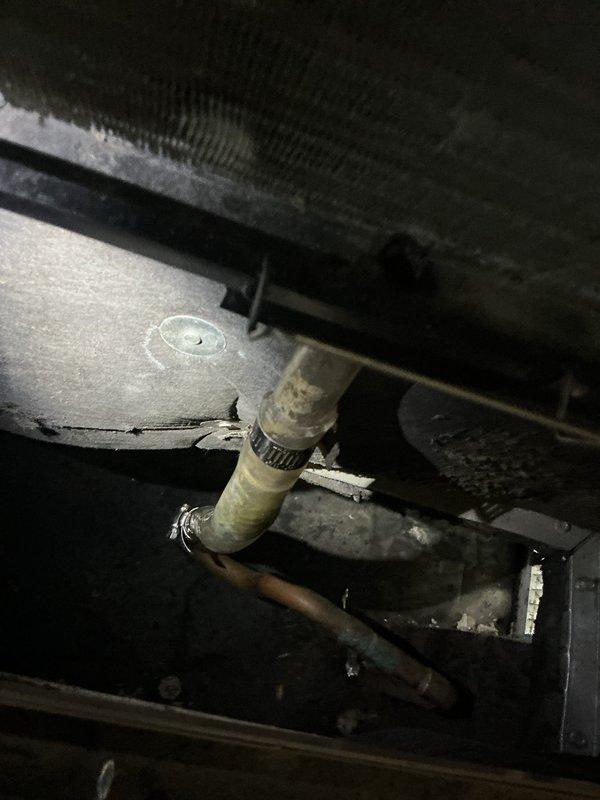Responded to service call for blockage in HVAC plumbing system. Upon arrival, accessed property via lockbox and contacted customer prior to entry as requested. Located and inspected HVAC air handler unit in confined attic space. Identified drainage issue affecting condensate drain line connected to the air handler. Examined flexible drainage hose, rigid piping, and connection points for obstruction. Cleared blockage from condensate drain system to restore proper water flow and prevent overflow conditions. Verified all drain line connections were secure and functioning correctly. Tested system operation to ensure condensate was draining properly without backup or leakage. Documented equipment condition and completed work with photographic records.