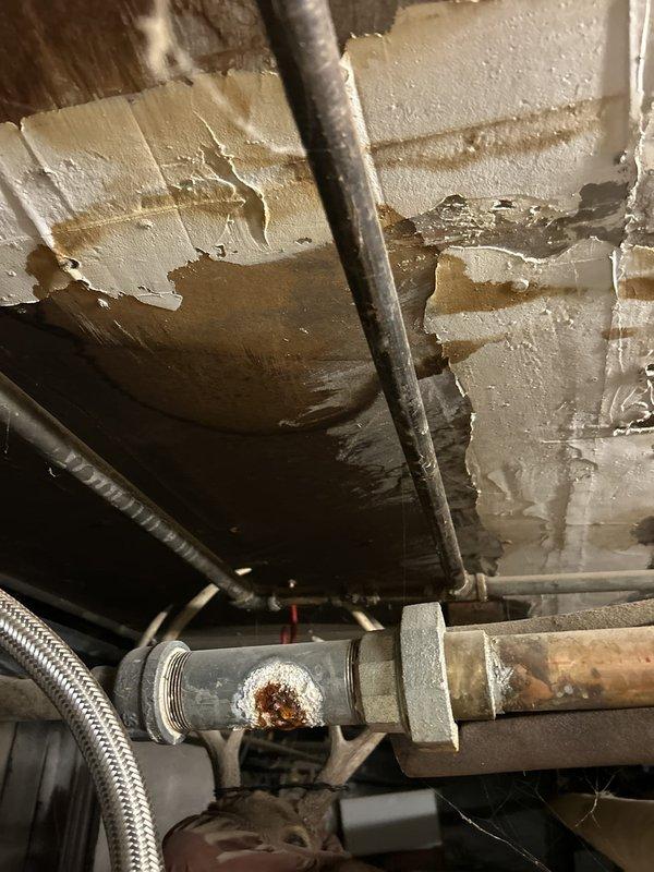 Completed initial assessment and preparation for gas pipe work installation at property with two existing water heaters (Rheem Performance Platinum and Bradford White Defender Safety System models). Observed significant infrastructure concerns including corroded gas piping connections with visible rust and deterioration on metal components, along with overhead water damage and peeling paint on ceiling surfaces indicating moisture intrusion issues. Yellow flexible gas lines currently connected to both water heater units. All necessary materials for gas pipe work have been delivered to site and staged for installation. Work scheduled to resume next business day to proceed with gas piping replacement and system upgrades. Documented existing conditions through photographic evidence showing current water heater installations, deteriorated piping assemblies, and compromised ceiling conditions in utility area.