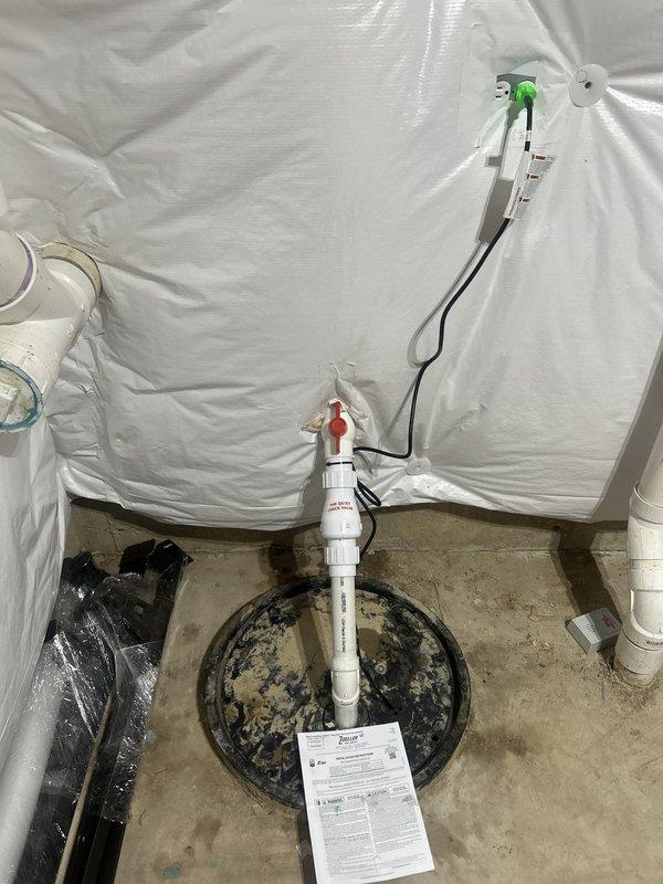 Completed installation of new sump pump system in basement utility area. Installed sump pump basin with vertical PVC discharge piping, red-handle check valve, and proper electrical connections to prevent basement flooding. System tested and verified operational, with all components properly secured and documentation provided to homeowner.