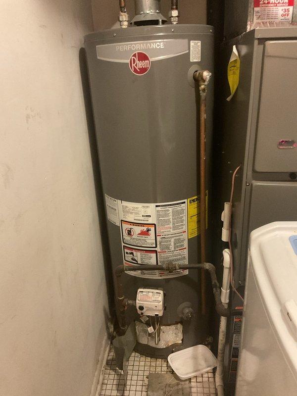 Completed water heater replacement in residential utility room. Removed existing unit and installed new Rheem Performance water heater with proper connections to copper supply lines and gas valve assembly. Configured all plumbing connections, integrated with existing ductwork and ventilation system including galvanized steel ducts and PVC piping. Verified proper installation, tested unit operation, and ensured all connections were secure and functioning correctly.