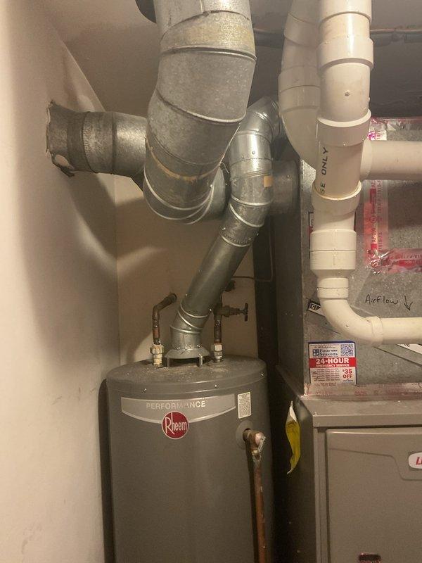 Completed water heater replacement in residential utility room. Removed existing unit and installed new Rheem Performance water heater with proper connections to copper supply lines and gas valve assembly. Configured all plumbing connections, integrated with existing ductwork and ventilation system including galvanized steel ducts and PVC piping. Verified proper installation, tested unit operation, and ensured all connections were secure and functioning correctly.