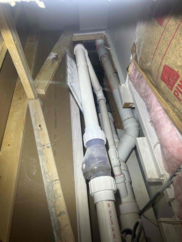 Conducted comprehensive site evaluation of residential plumbing system to assess drainage and sewer infrastructure. Inspected crawl space plumbing configuration, documenting multiple PVC drain lines and their routing through floor joists. Evaluated basement area conditions and accessibility for potential drainage work. Documented existing plumbing layout and structural considerations for estimate preparation.