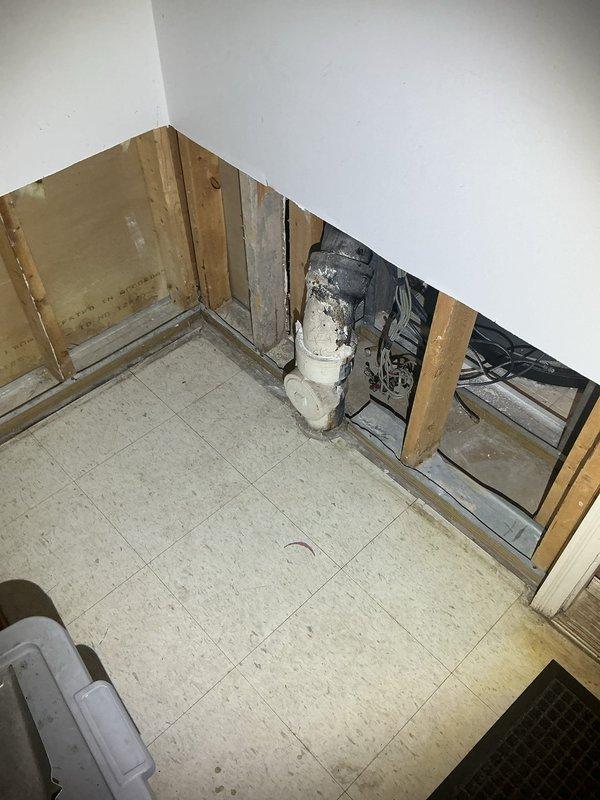 Completed comprehensive drain and sewer assessment for residential property experiencing flooding concerns. Inspection revealed interior wall damage requiring removal of drywall to access plumbing infrastructure and evaluate drainage system integrity. Documented exposed wall framing, vertical piping, and existing tile flooring conditions in affected interior area. Exterior evaluation included examination of backyard drainage components, artificial turf installation, and ground-level access points including visible drain covers in paved patio area. Provided estimate for flood prevention methods and recommended drainage solutions to address water intrusion issues.