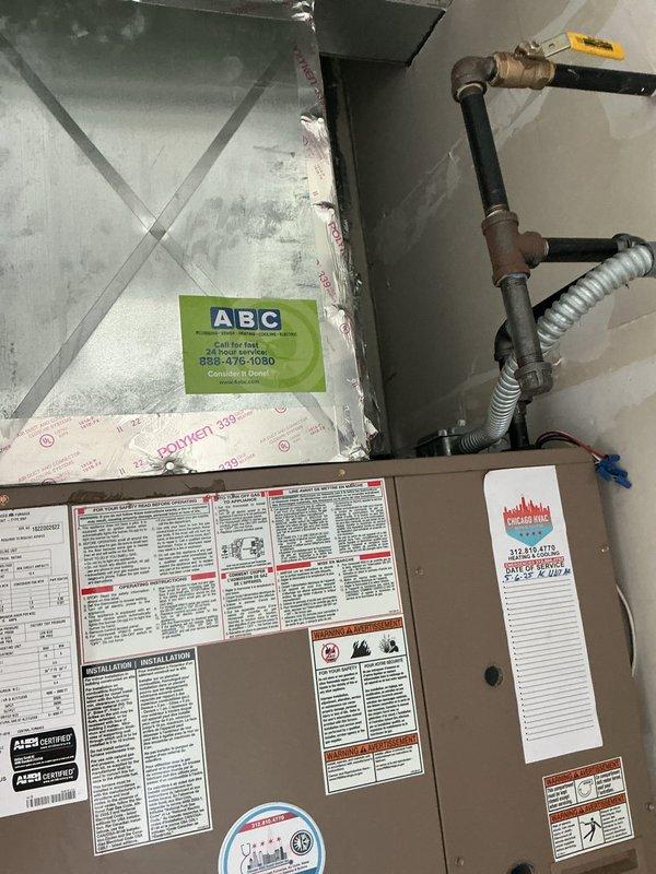 Performed inspection of HVAC system installation in attic space, evaluating furnace/air handler unit, metal ductwork with cross-braced support structure, and associated refrigerant lines. Documented existing system conditions including heat exchanger coils, copper piping connections with brass fittings, flexible metallic tubing, and mounting hardware showing normal operational wear and dust accumulation consistent with system age.