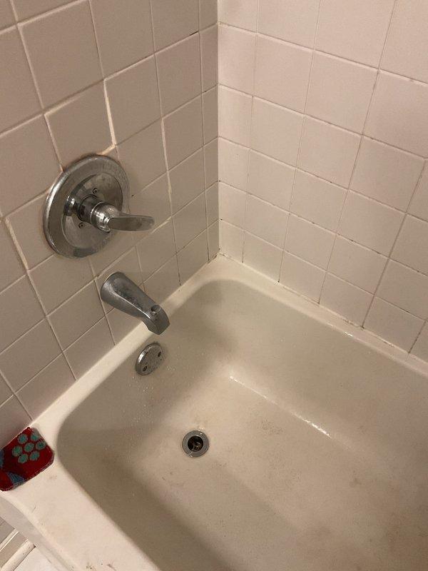Responded to service call for clogged bathtub and kitchen sink. Upon arrival, inspected both fixtures and confirmed drainage issues. Accessed kitchen sink plumbing through cabinet to assess trap and drain line configuration. Utilized mechanical snaking equipment to clear obstructions from both the bathtub drain line and kitchen sink drain. Successfully restored proper drainage flow to both fixtures. Documented existing conditions including under-sink plumbing layout with garbage disposal unit. Tested both drains after clearing to verify complete restoration of function.