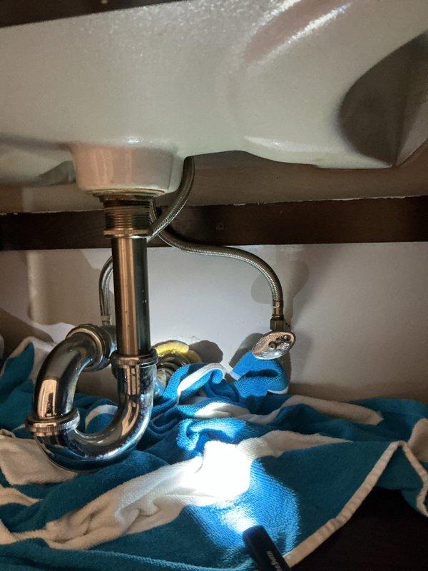 Replaced deteriorated bathroom sink faucet assembly due to rust and corrosion. Disconnected existing water supply lines, removed old faucet fixture, installed new faucet with updated drain assembly and P-trap connections, verified proper water flow and drainage, and confirmed no leaks at all connection points.