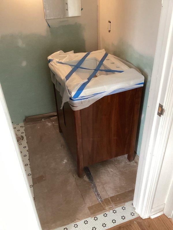 Responded to recall to correct improperly installed shower valve. Cut out existing valve, diverted water supply lines, and reinstalled valve at proper depth per code requirements. Completed installation of vanity cabinet, faucet, and toilet fixture. All plumbing connections secured and tested for proper operation.