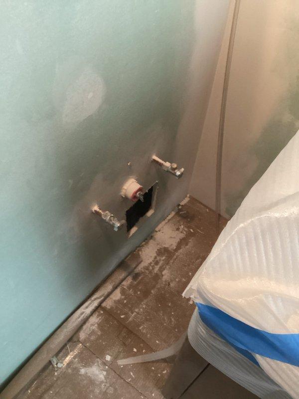 Responded to recall to correct improperly installed shower valve. Cut out existing valve, diverted water supply lines, and reinstalled valve at proper depth per code requirements. Completed installation of vanity cabinet, faucet, and toilet fixture. All plumbing connections secured and tested for proper operation.