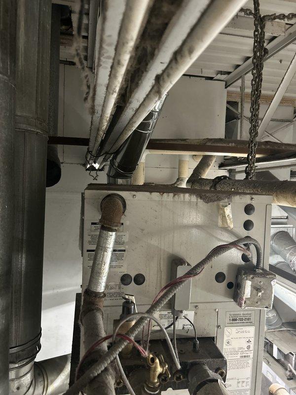 Responded to emergency no-water call at commercial laundry facility. Upon inspection, discovered issue was related to HVAC system components rather than plumbing infrastructure. Inspected air handler unit, ductwork, and associated mechanical systems in ceiling space. Documented equipment condition including insulated refrigerant lines, furnace components, and control systems. No water pressure issues identified in plumbing lines; determined water supply interruption was unrelated to photographed HVAC equipment.