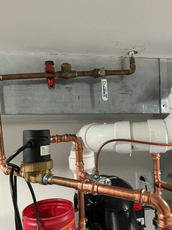Responded to customer concern regarding banging pipes following recent water heater installation. Upon investigation, identified water hammer issue caused by rapid valve closure in the domestic hot water system. Inspected the complete installation including the water heater, recirculation pump assembly, copper supply lines, pressure relief valve, and associated fittings. Verified all connections were properly secured and soldered joints were sound. Evaluated the expansion tank mounting and pressure settings to ensure proper system operation. Confirmed the recirculation pump was functioning correctly and all shut-off valves were operating smoothly. The copper piping configuration and support brackets were examined to identify potential vibration points. Addressed the water hammer condition to eliminate the banging noise and ensure quiet system operation. All components tested and verified to be working within normal parameters upon completion.