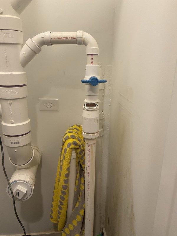 Responded to emergency plumbing call for failed sump pump discharge assembly. Upon arrival, identified a cracked plastic union collar on the Campbell 'The Silencer' silent check valve (model CVUCSL15) that was spraying water during pump operation. The pump had been unplugged and isolation ball valve closed as a temporary measure. Replaced the defective check valve assembly with new unit, reconnected 1.5" PVC discharge piping, and tested system operation to verify proper function and leak-free performance.