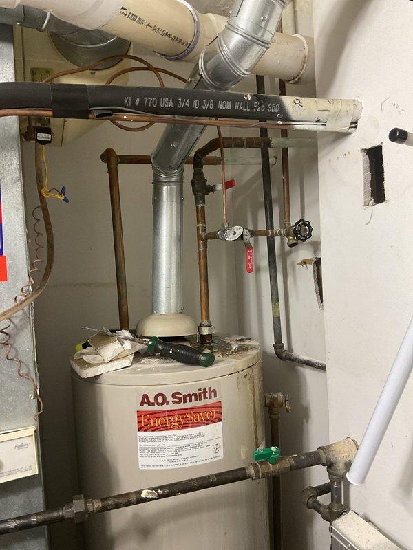 Responded to commercial service call for reported leak potentially caused by clogged drain line. Upon inspection, assessed water heater installation area and surrounding plumbing systems, including copper supply lines, pressure relief components, and drain connections. Documented existing conditions of plumbing infrastructure, including shut-off valves, pressure gauges, and drainage pathways to identify source of reported leak and determine if drain blockage was contributing factor.