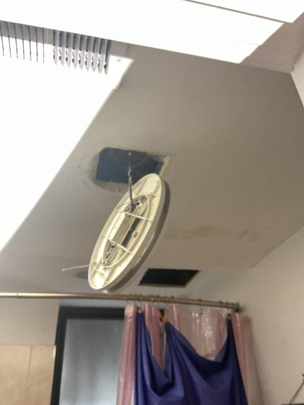 Responded to a multiunit water leak emergency in a century-old building affecting five floors from top to bottom. Upon arrival, conducted thorough investigation of the fifth-floor unit where dripping sounds were reported within the wall cavity, though no visible water damage was present at the time of inspection. Traced the leak pathway through multiple units to assess the extent of water infiltration and potential structural impact. Documented conditions with photographic evidence of ceiling fixtures and surrounding areas to establish baseline damage assessment. Due to the age of the building and complexity of the plumbing system running through multiple units, identified the need for further invasive investigation to locate the exact source of the leak within the wall structure.