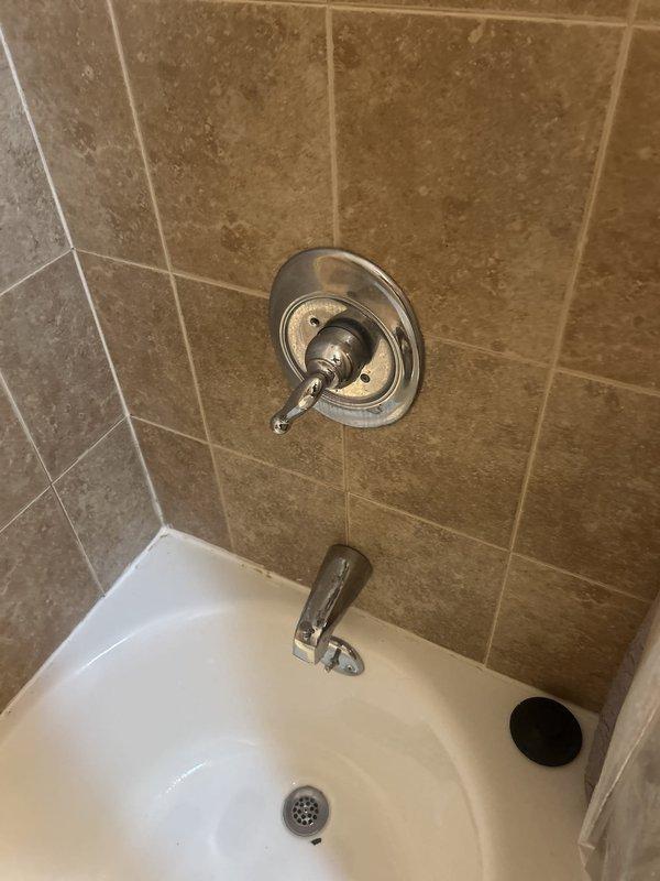 Responded to no-water callback following previous service visit. Inspected plumbing connections beneath sink fixture and bathtub installation. Documented existing conditions including discolored mounting hardware and PVC pipe connections under sink, along with standard bathroom plumbing fixtures including chrome faucet assembly and tub spout. Assessed water supply system to identify and resolve service interruption issue, restoring water flow to the residence.