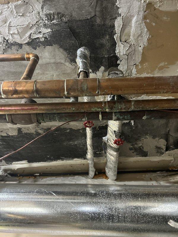 Coordinated building-wide water shutoff with condo association to replace failed angle stop valve serving Unit 3. Shut down main water supply to building during scheduled window, notified residents of temporary service interruption, and replaced corroded angle stop valve on copper supply line. Restored water service to building and verified proper operation of new valve with no leaks detected.