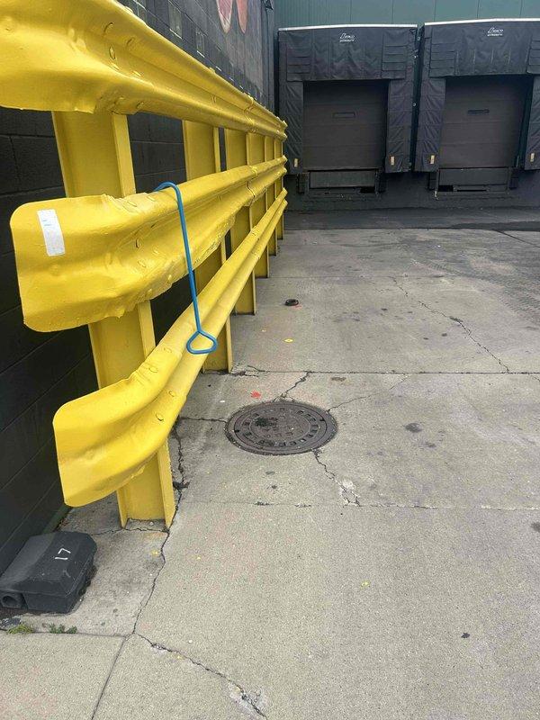 Conducted comprehensive drain and sewer system assessment at commercial facility, documenting conditions of underground infrastructure and building plumbing components. Inspection revealed severely corroded vertical cast iron waste stack in basement utility area with advanced oxidation requiring attention, along with evaluation of exterior loading dock area including underground sewer access points and drainage systems serving the warehouse operations.