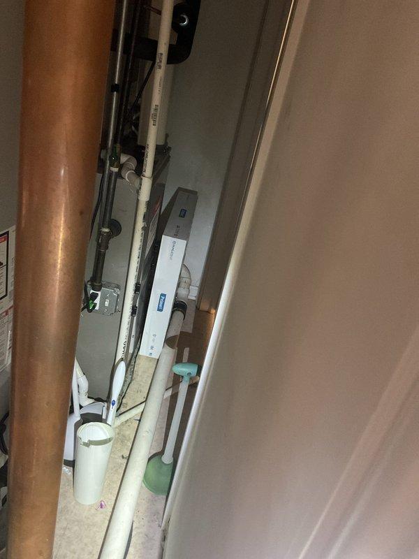 Responded to service call for sump pump evaluation after unit failed to adequately manage water during recent rainfall. Conducted thorough inspection of existing sump pump system in utility closet, examining pump capacity, discharge piping including copper and PVC components, and overall system performance. Assessed mechanical equipment, mounting hardware, and drainage configuration to determine cause of inadequate water removal. Documented current system conditions with photographs showing corroded copper piping, aged mechanical components with significant dust accumulation, and pump assembly located in confined utility space. Provided estimate for sump pump replacement to restore proper water management capacity for the residential unit.