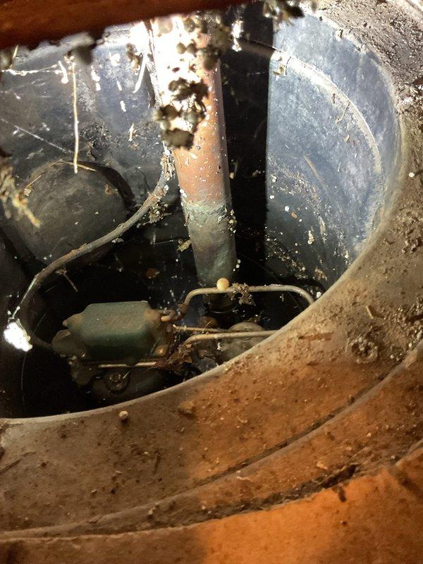 Responded to service call for sump pump evaluation after unit failed to adequately manage water during recent rainfall. Conducted thorough inspection of existing sump pump system in utility closet, examining pump capacity, discharge piping including copper and PVC components, and overall system performance. Assessed mechanical equipment, mounting hardware, and drainage configuration to determine cause of inadequate water removal. Documented current system conditions with photographs showing corroded copper piping, aged mechanical components with significant dust accumulation, and pump assembly located in confined utility space. Provided estimate for sump pump replacement to restore proper water management capacity for the residential unit.