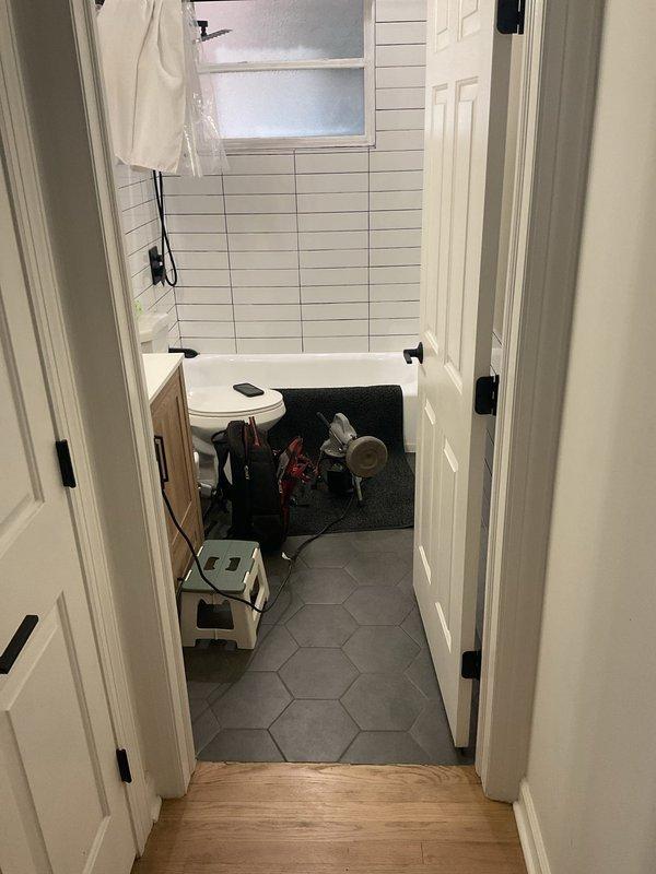 Responded to a slow-draining bathtub issue in a residential bathroom. Utilized RIDGID drain cleaning equipment to clear the obstruction and restore proper drainage flow. Successfully completed the drain clearing service and documented the work area and equipment used.
