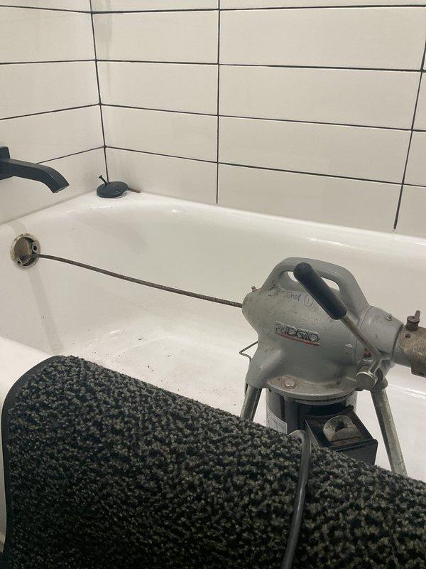 Responded to a slow-draining bathtub issue in a residential bathroom. Utilized RIDGID drain cleaning equipment to clear the obstruction and restore proper drainage flow. Successfully completed the drain clearing service and documented the work area and equipment used.