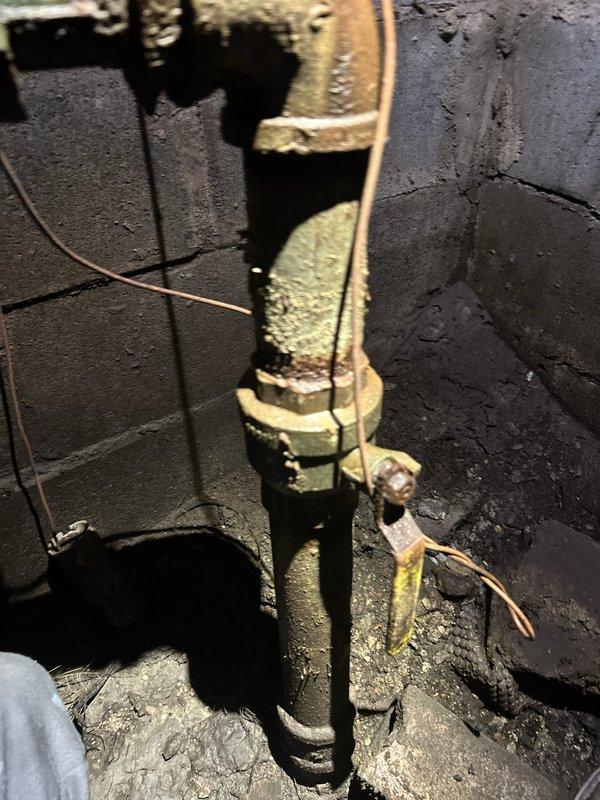 Conducted initial site assessment for commercial tankless water heater installation. Documented existing plumbing infrastructure, including heavily corroded copper piping with extensive yellow-green oxidation and mineral buildup at water meter assembly and vertical supply lines. Installation requires return visit to complete tankless water heater system commissioning.