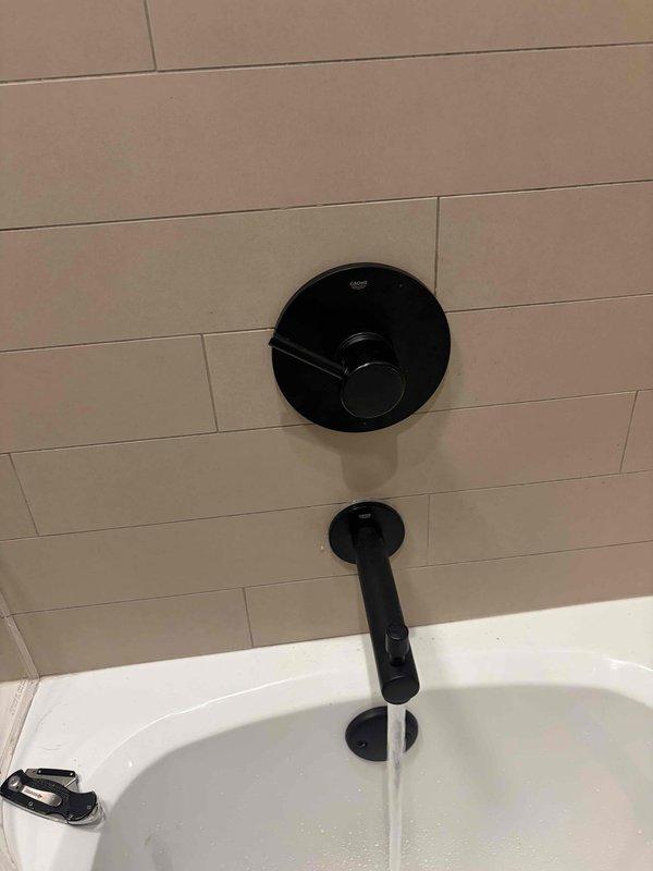 Responded to warranty callback for previously installed Grohe shower trim kit in guest bathroom. Upon inspection, identified that the shower valve handle was improperly oriented during initial installation. Removed and reinstalled the handle assembly in correct position, ensuring proper operation and alignment. Verified full range of motion and tested water flow control to confirm proper functionality. Replaced worn rubber grommet component during reassembly. System now operating as designed with handle correctly positioned for intuitive use.