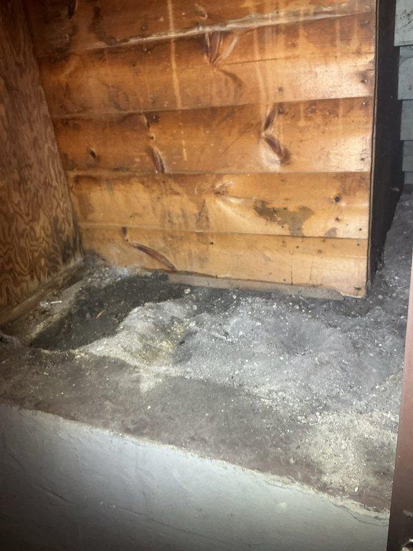 Responded to service call for removal of deteriorated brick-lined catch basin. Upon arrival, documented existing conditions showing aged circular brick structure with significant mortar deterioration and weathered masonry. The catch basin shaft exhibited traditional arched brickwork construction with loose and displaced bricks throughout. Basin contained standing water at bottom of shaft. Successfully removed old catch basin structure from property. Work area located in unfinished utility space with exposed wooden walls and concrete flooring. All debris from removal process cleared from site and surrounding area left clean.
