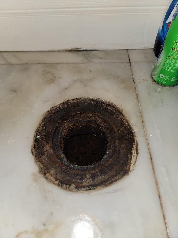 Responded to water leak emergency in century-old residential property where leaking toilet had caused water damage to unit below. Upon arrival, inspected toilet assembly, water supply connections, and floor drain system. Identified source of leak at toilet base and assessed extent of water intrusion through floor. Performed necessary repairs to toilet seal and water supply line, tested all connections for proper operation, and verified leak was resolved. Cleaned and sanitized affected floor area around toilet and drain opening to prevent mold growth and ensure sanitary conditions following water exposure.