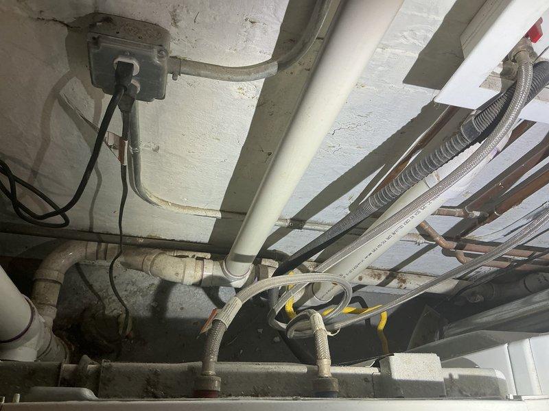 Conducted comprehensive site assessment for residential flood control system installation. Evaluated existing basement drainage infrastructure and plumbing configuration to determine optimal placement for backflow prevention valve and ejector pit system. Inspected mechanical room ceiling area, identifying current utility routing including water supply lines, electrical conduits, and existing drainage pipes to plan integration points for new flood control components. Examined exterior basement entrance stairwell and lower level access points to assess potential water intrusion pathways and drainage concerns. Documented existing conditions through photographs of ceiling-mounted utilities and exterior entrance configuration. Discussed flood control options with property owner, reviewing backflow valve specifications and ejector pit requirements based on observed site conditions. Provided professional recommendations for comprehensive basement flood prevention system tailored to property's