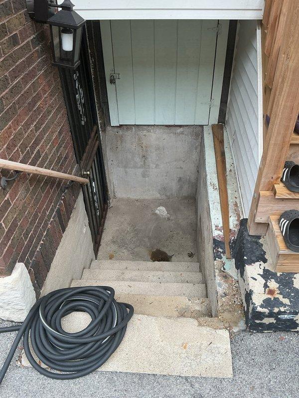 Conducted comprehensive site assessment for residential flood control system installation. Evaluated existing basement drainage infrastructure and plumbing configuration to determine optimal placement for backflow prevention valve and ejector pit system. Inspected mechanical room ceiling area, identifying current utility routing including water supply lines, electrical conduits, and existing drainage pipes to plan integration points for new flood control components. Examined exterior basement entrance stairwell and lower level access points to assess potential water intrusion pathways and drainage concerns. Documented existing conditions through photographs of ceiling-mounted utilities and exterior entrance configuration. Discussed flood control options with property owner, reviewing backflow valve specifications and ejector pit requirements based on observed site conditions. Provided professional recommendations for comprehensive basement flood prevention system tailored to property's