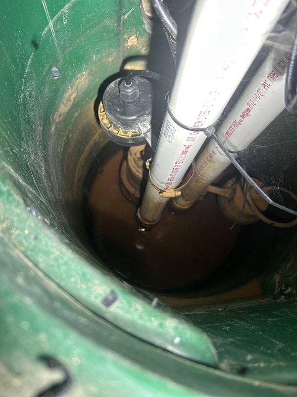 Performed warranty service on residential hydronic heating circulation system. Inspected and verified operation of circulation pump, digital control unit, and associated piping assembly including white PVC supply lines, ball valve shut-offs, and threaded unions. Confirmed proper function of pump mounted in protective housing, checked electrical connections and control wiring, and documented system configuration with red-handled isolation valves in serviceable condition for future maintenance access.