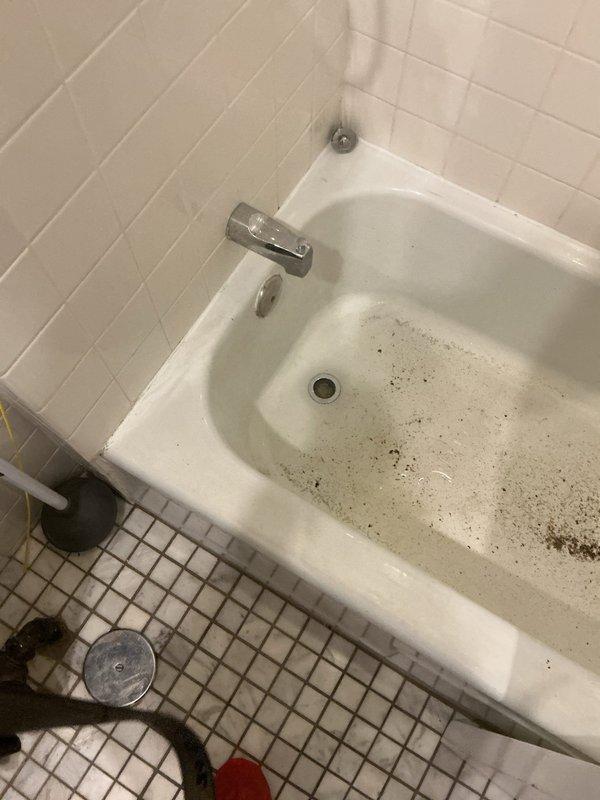 Responded to a clogged drain service call and successfully cleared a bathtub drain obstruction. Upon arrival, found the tub with significant drainage issues and visible standing water staining. Used professional drain cleaning equipment to remove the blockage and restore proper water flow, then tested the system to ensure complete drainage functionality.