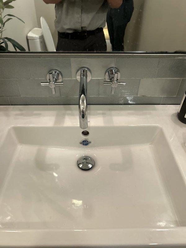 Responded to service call for multiple plumbing issues throughout the residence. Addressed leaking Kohler MasterShower body spray head, inspecting valve assembly and replacing worn internal components to eliminate water seepage. Serviced powder room sink faucet with dripping spout and loose handle—disassembled wall-mounted fixture, replaced deteriorated cartridge seals, tightened mounting hardware, and tested both hot and cold water controls for proper operation. Diagnosed reduced hot water flow at kitchen sink faucet while cold water pressure remained normal. Removed and cleaned aerator, finding mineral buildup and debris restricting flow. Inspected supply line connections beneath sink and confirmed no obstruction in hot water supply valve. All fixtures tested and verified operational with no leaks upon completion.