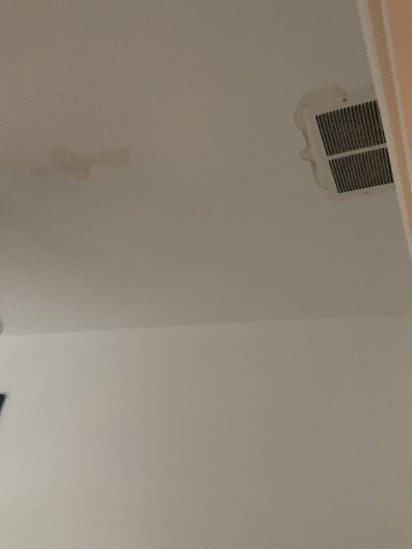 Responded to follow-up water leak investigation after restoration company identified dishwasher as possible source. Inspected ceiling damage in affected area showing evidence of water intrusion near HVAC vent, and examined Frigidaire dishwasher installation beneath granite countertop. Documented conditions with photographs of water-damaged ceiling and dishwasher unit for assessment and future repair reference.