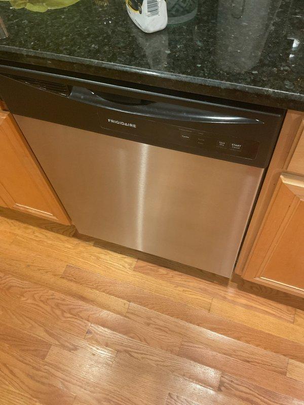 Responded to follow-up water leak investigation after restoration company identified dishwasher as possible source. Inspected ceiling damage in affected area showing evidence of water intrusion near HVAC vent, and examined Frigidaire dishwasher installation beneath granite countertop. Documented conditions with photographs of water-damaged ceiling and dishwasher unit for assessment and future repair reference.
