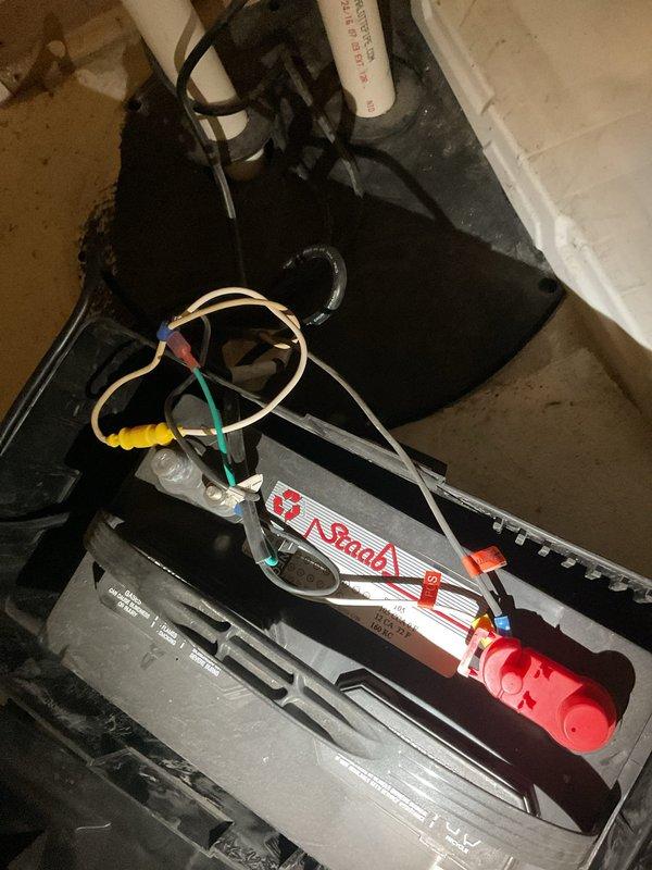 Conducted on-site assessment for sump pump replacement in residential property. Evaluated existing sump pump system including pump unit, discharge piping, backup battery system, and basin configuration. Documented current equipment condition and workspace layout, noting the presence of a backup battery power system and associated components. Provided comprehensive estimate for complete sump pump replacement including removal of existing unit and installation of new primary pump system.