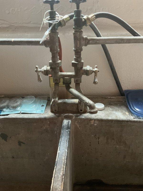 Completed VIP plumbing maintenance inspection of residential water supply system and under-sink plumbing. Documented condition of bathroom vanity cabinet P-trap assembly and main water supply manifold with dual shut-off valves, confirming all connections secure and operational.