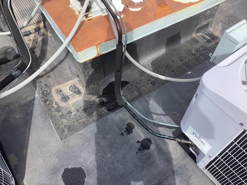 Responded to service call for exterior pipe leak. Upon inspection, located leaking pipe on exterior of building near rooftop HVAC equipment. Documented existing conditions including water damage and staining on roofing membrane surface. Photographed affected areas showing leak source, associated plumbing lines, and surrounding mechanical equipment. Provided assessment and repair recommendations to customer for permanent resolution of the active leak.