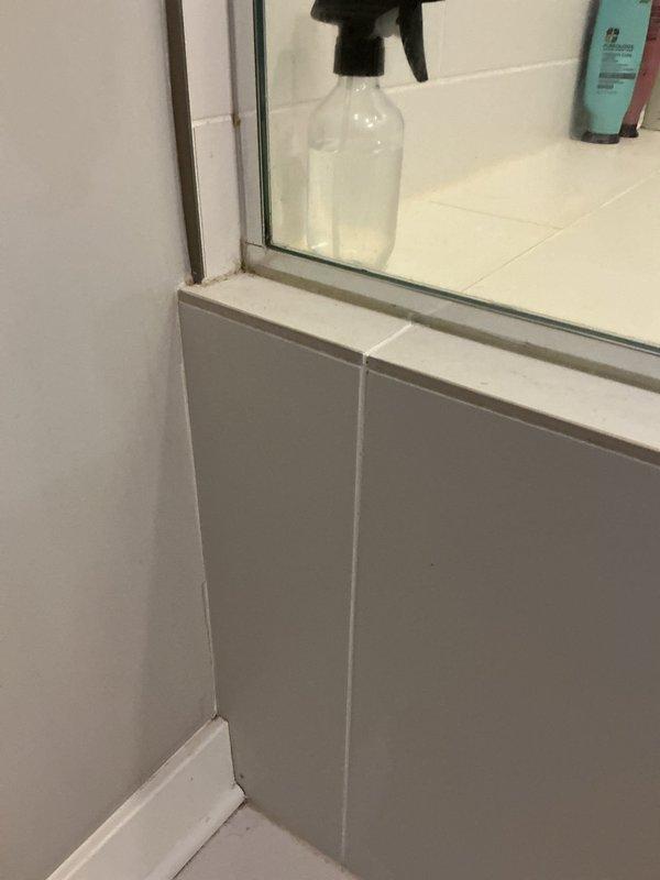 Responded to report of water leak causing damage to shower ceiling. Conducted thorough inspection of bathroom area to locate source of moisture intrusion. Examined wall and floor junctions, door threshold transitions, and adjacent surfaces for signs of water penetration. Assessed conditions around shower enclosure including corners, baseboards, and trim areas where water infiltration commonly occurs. Documented findings with photographic evidence showing inspection points at doorway threshold, wall corners, and bathroom fixtures. Identified potential leak pathways and moisture damage indicators requiring further investigation or repair work.